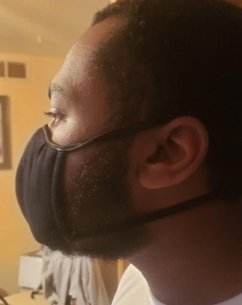 African American young man wearing black face mask.