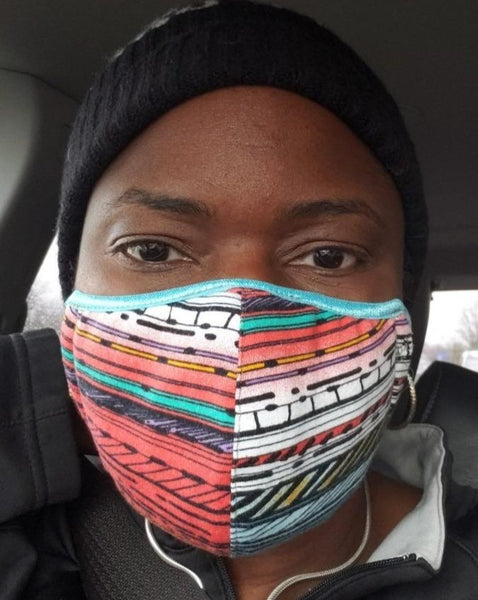 African American woman wearing multi-colored mask.