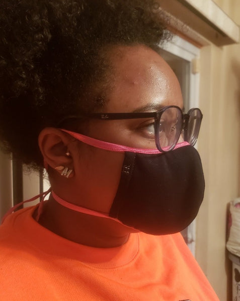 African American teenage girl wearing black face mask with pink elastic ties.