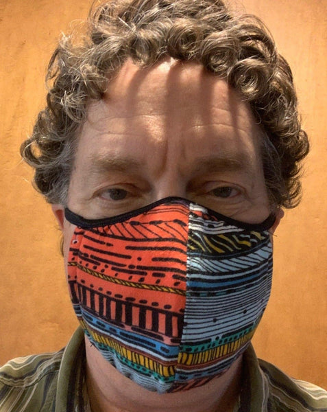 White man wearing multi-colored mask.